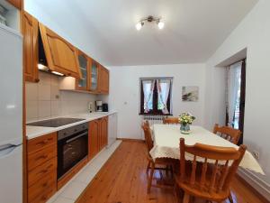 a kitchen with a table and chairs and a dining room at Villa Dina in Tar