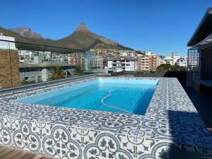 a swimming pool on the roof of a building at Apartment in Sea Point. in Cape Town