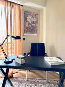 a desk with a lamp and a chair in a room at SIMONE LUXURY SUITE, Central Modern Apartment 82sqm with Terrace in Tripoli