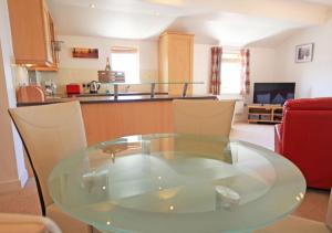 a glass table and chairs in a living room at No 2 The Viking in Seahouses