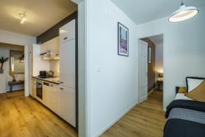 a small apartment with white walls and a kitchen at Heart of Interlaken Apartments in Interlaken +69 photos
