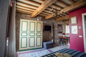 a bedroom with a door and a table in a room at La Viola di Assisi in Assisi