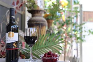 Or ‘Aqīvāhにあるסוויטה מפוארת 800 מטר מהים קיסריהの赤ワインのグラスの横にワイン1本