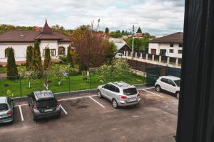 a group of cars parked in a parking lot at Casa Novis in Băicoi