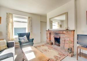 a living room with a fireplace and a mirror at Bolams Lodge in Ancroft