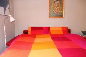 een bed met een kleurrijke deken erop bij CaseOspitali - Casatita, un nido x2 vicino Università di Trento in Trento