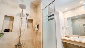 a bathroom with a shower and a sink at Club Reef Resort & Spa in Sharm El Sheikh