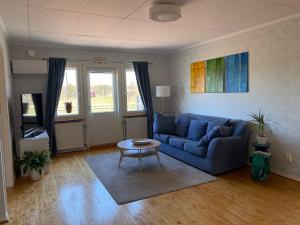 a living room with a blue couch and a table at Villa Valentina in Lemland