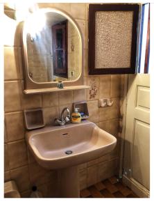 a bathroom with a sink and a mirror at Partarolos Traditional House in Apérathos +29 photos