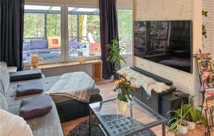 een woonkamer met een bank en een open haard bij 1 Bedroom Cozy Home In rkelljunga in Orkelljunga