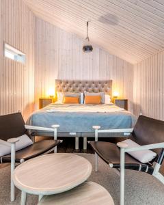 a bedroom with a large bed and two chairs at Arctic Bath in Harads