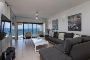 a living room with a couch and a table at 802 The Bermudas - by Stay in Umhlanga in Durban