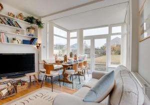 a living room with a couch and a table at Sandy Dell in Beadnell