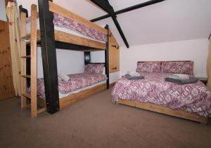 a bedroom with two bunk beds in a room at Little Dod Barn in Ilderton