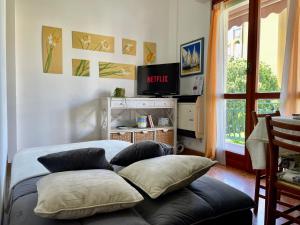 a bedroom with two pillows on a bed with a television at Relax a 800 mt dal Mare - Free Parking, A/C e WiFi in Pietra Ligure