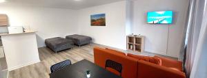 a living room with a couch and a table at City Apartments in Neuss