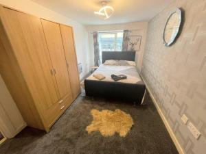 a small bedroom with a bed and a mirror at Halifax central shortstay in Halifax