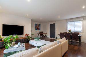 ein Wohnzimmer mit einem Sofa und einem Flachbild-TV in der Unterkunft Baraka in Salon-de-Provence