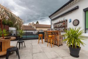 eine Terrasse mit Tischen und Stühlen sowie eine Bar in der Unterkunft Baraka in Salon-de-Provence