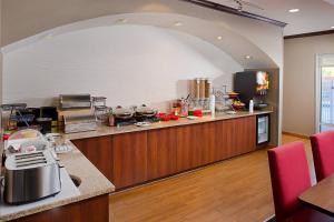 a large kitchen with an archway in the middle at TownePlace Suites by Marriott Fayetteville N / Springdale in Johnson