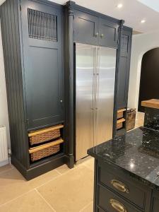 a bathroom with a glass refrigerator and a counter at Beautiful 3 bed cottage in Lymington. Perfectly located for Coast and New Forest in Lymington
