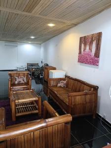 a room with wooden benches and a painting on the wall at Hostel Sao Gabriel in São Tomé