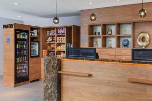 a bar in a hotel lobby with a tv at Four Points by Sheraton Panoramahaus Dornbirn in Dornbirn
