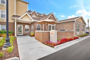 a brick house with a sign that says office at TownePlace Suites by Marriott Brookfield in Brookfield