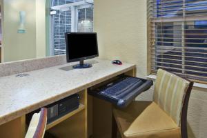 a computer desk with a keyboard and a computer monitor at TownePlace Suites by Marriott Brookfield in Brookfield