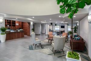 a lobby with chairs and a living room at Four Points by Sheraton Fort Lauderdale Airport - Dania Beach in Dania Beach