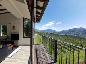 a balcony with a view of a vineyard at Casa Ghiro in Pura