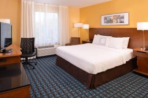 a hotel room with a bed and a desk and a television at Fairfield Inn & Suites by Marriott Anderson Clemson in Anderson