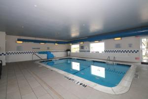 a large swimming pool in a building at Fairfield Inn & Suites Dallas Lewisville in Lewisville