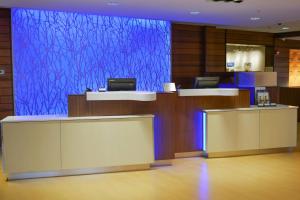 a lobby with a blue screen in a building at Fairfield Inn and Suites Canton South in Canton