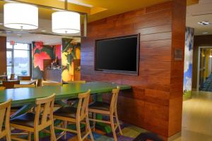 - une salle de conférence avec une table et une télévision murale dans l'établissement Fairfield Inn and Suites Canton South, à Canton