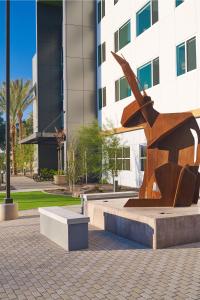 a statue in front of a tall building at Element Chandler Fashion Center in Chandler