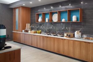 a restaurant with a counter with food on it at SpringHill Suites by Marriott Atlanta Northwest in Atlanta