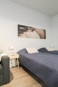 a bedroom with a bed and a chair and a desk at City Apartment Myllyntupa in Kuopio