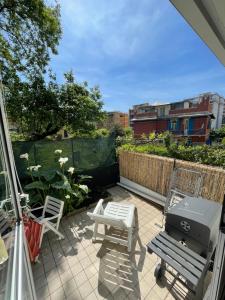 a patio with a grill and chairs on a balcony at Victoria's House in Rapallo