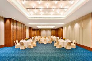 a banquet hall with white tables and chairs at Fairfield by Marriott Jodhpur in Jodhpur