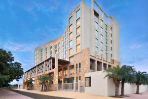 a rendering of a building with palm trees in front at Fairfield by Marriott Jodhpur in Jodhpur