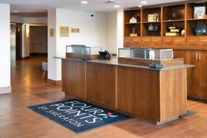 an office lobby with a reception desk and a welcome mat at Four Points by Sheraton Allentown Lehigh Valley in Allentown