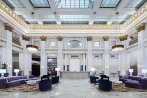 a large lobby with purple chairs and a stage at The Westin Great Southern Columbus in Columbus