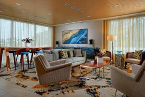 a living room with a couch and a table at Delta Hotels by Marriott Daytona Beach Oceanfront in Daytona Beach