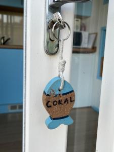 a lock on a door with the word cola on it at Coral Shepherds Hut in Penally