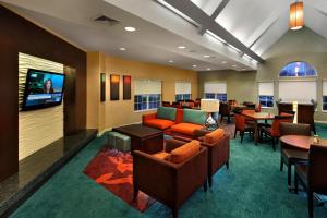 a hotel lobby with couches and a flat screen tv at Residence Inn Danbury in Danbury