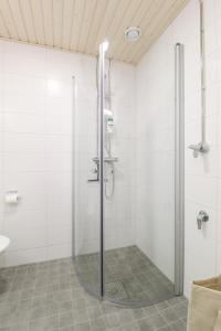 a shower with a glass door in a bathroom at City Apartment Myllyntupa in Kuopio