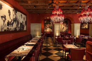 a dining room with long tables and chandeliers at Renaissance Lucerne Hotel in Lucerne