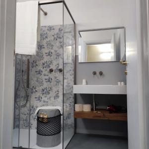 a bathroom with a shower and a sink and a mirror at Hotel Riviera in San Vito lo Capo