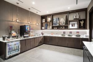 a large kitchen with a counter with a refrigerator at Residence Inn by Marriott Weehawken in Weehawken